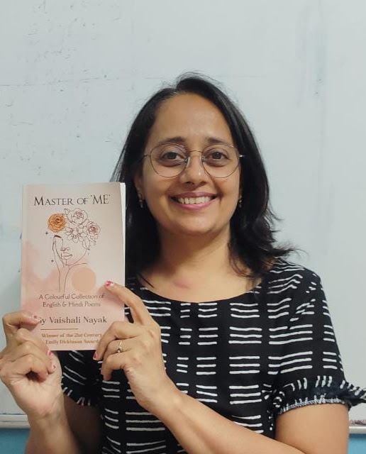 Vaishali Nayak smiling and holding her book Master of ‘ME’
